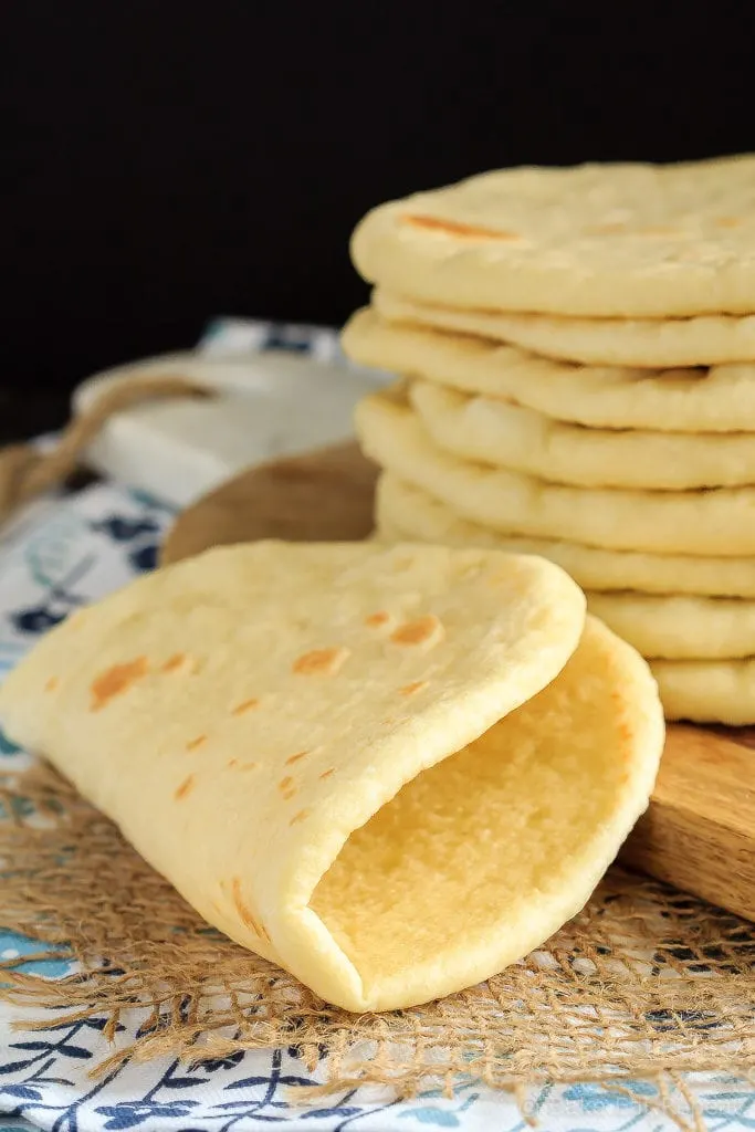 This homemade soft flatbread recipe is super easy to make and is perfect for sandwiches, gyros or even mini pizzas!