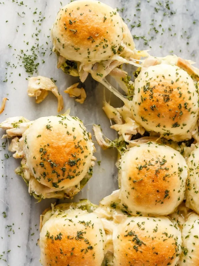 These easy to make, pesto chicken pull apart sliders are the perfect quick and easy dinner - and the leftover sliders are amazing for lunch the next day!