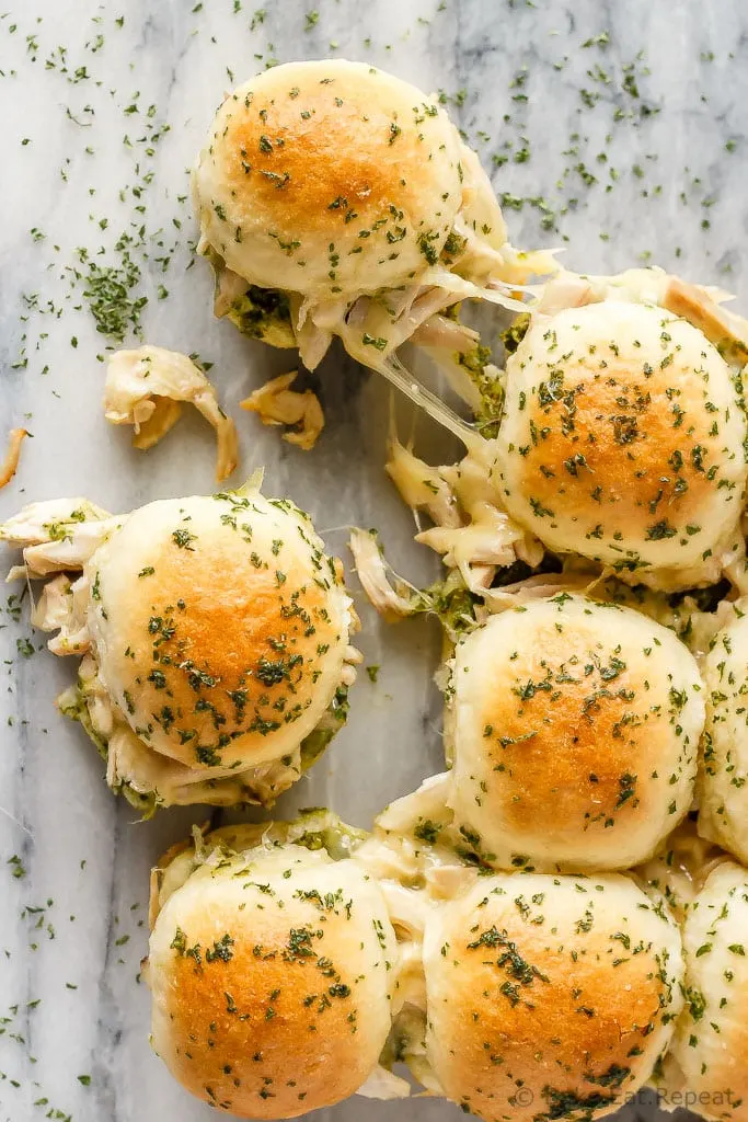 These easy to make, pesto chicken pull apart sliders are the perfect quick and easy dinner - and the leftover sliders are amazing for lunch the next day!