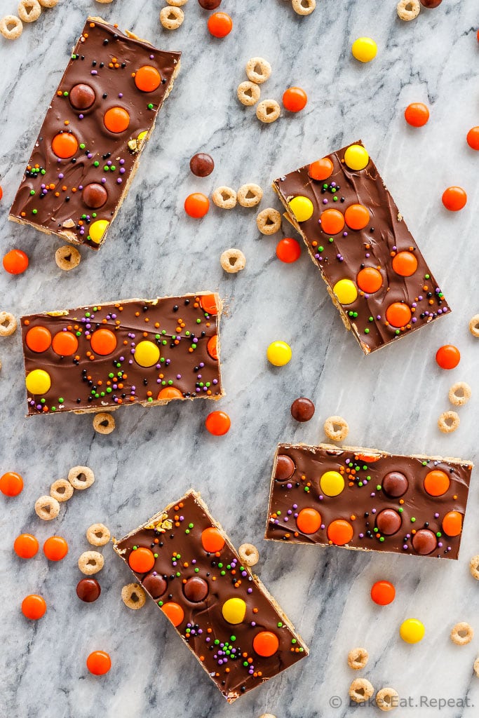 These crunchy chocolate peanut butter granola bars use cereal and oats for an easy, no bake treat - with yellow and orange candy for a fun Halloween snack!