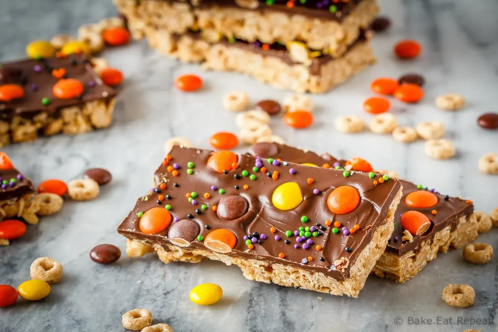 These crunchy chocolate peanut butter granola bars use cereal and oats for an easy, no bake treat - with yellow and orange candy for a fun Halloween snack!