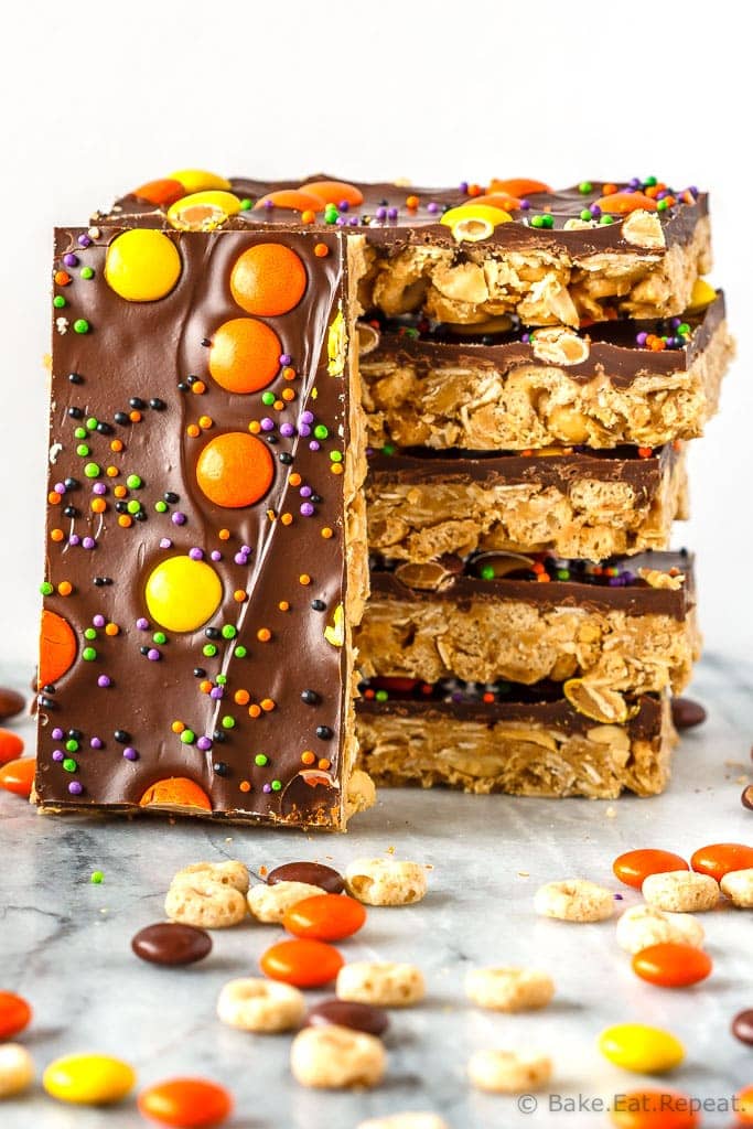 These crunchy chocolate peanut butter granola bars use cereal and oats for an easy, no bake treat - with yellow and orange candy for a fun Halloween snack!