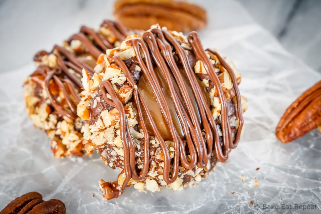 These turtle thumbprint cookies are amazing! Rich chocolate cookies rolled in chopped pecans, topped with salted caramel sauce and drizzled in chocolate!