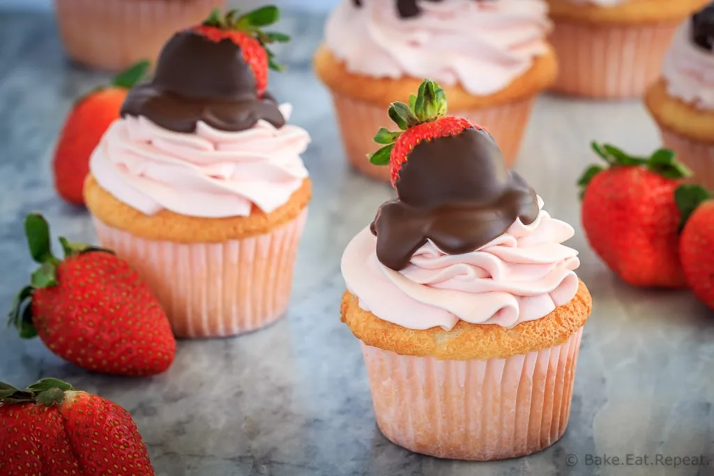 These chocolate covered strawberry cupcakes are the perfect sweet treat for Valentine's Day - angel food cupcakes with strawberry whipped cream frosting!