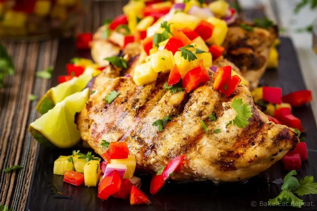 This lemon garlic grilled chicken with pineapple salsa is quick and easy to make and is the perfect summer meal! Juicy grilled chicken with fruit salsa!
