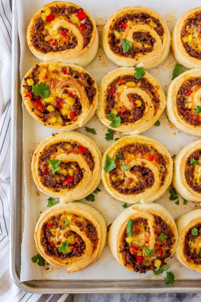 These taco pizza rolls are easy to make and taste amazing! Homemade pizza dough wrapped around taco meat, cheese and veggies - perfect for lunch or dinner!