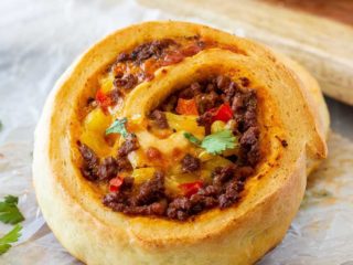 These taco pizza rolls are easy to make and taste amazing! Homemade pizza dough wrapped around taco meat, cheese and veggies - perfect for lunch or dinner!