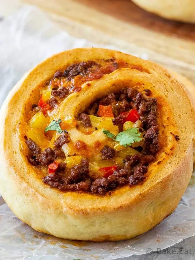 These taco pizza rolls are easy to make and taste amazing! Homemade pizza dough wrapped around taco meat, cheese and veggies - perfect for lunch or dinner!