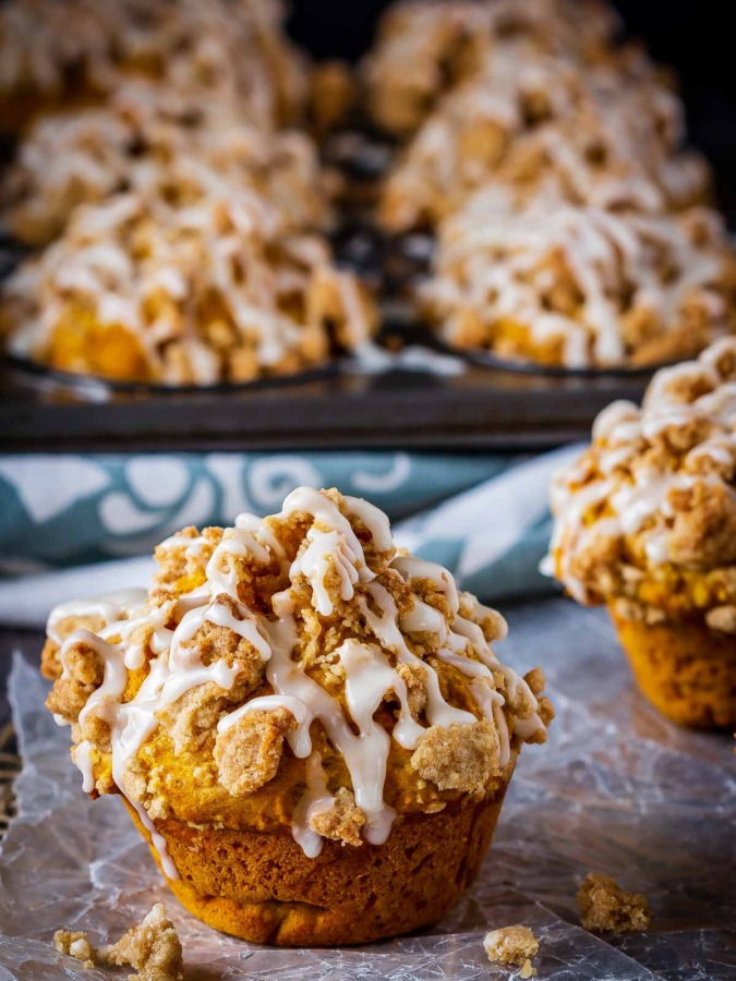 These bakery style pumpkin spice muffins are delicious on their own - but add that crumb topping and drizzle them with a maple glaze and they're amazing!