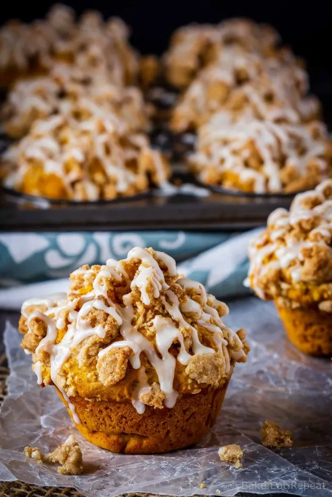 These bakery style pumpkin spice muffins are delicious on their own - but add that crumb topping and drizzle them with a maple glaze and they're amazing!