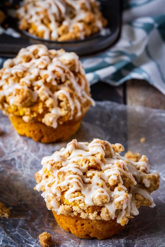 These bakery style pumpkin spice muffins are delicious on their own - but add that crumb topping and drizzle them with a maple glaze and they're amazing!