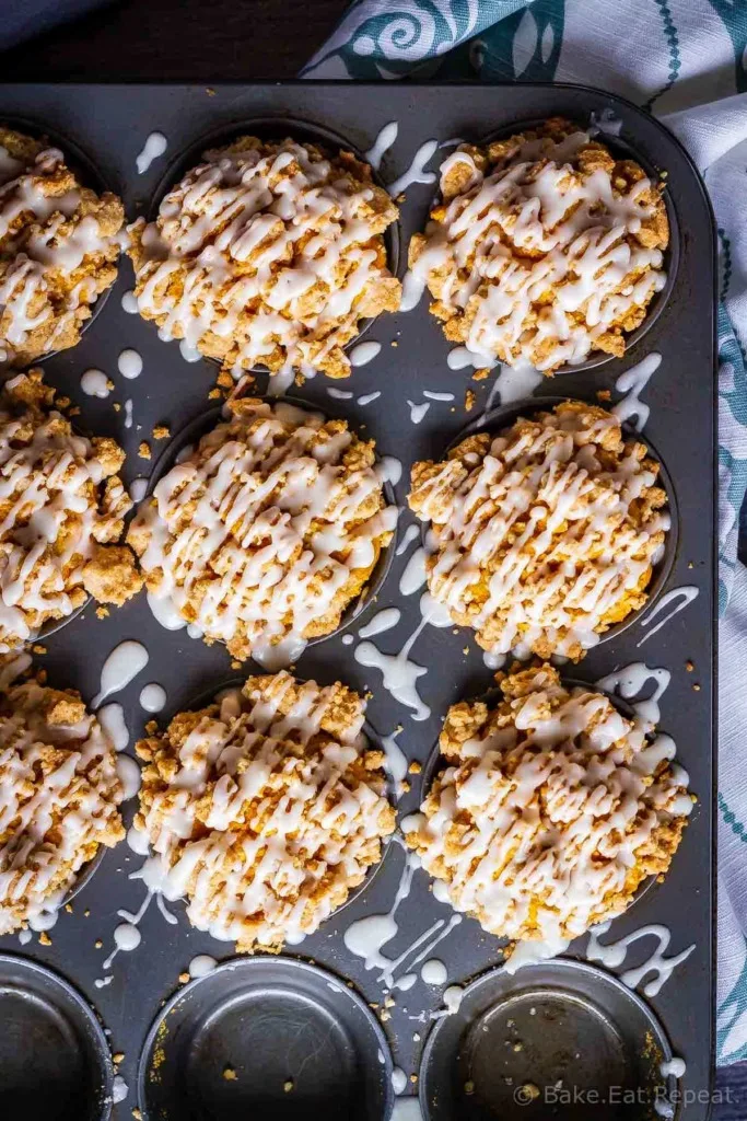 These bakery style pumpkin spice muffins are delicious on their own - but add that crumb topping and drizzle them with a maple glaze and they're amazing!