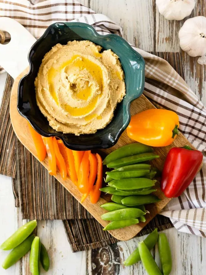 This easy roasted garlic hummus is silky smooth and full of roasted garlic flavour. Quick and easy to make, this homemade hummus is the perfect snack!