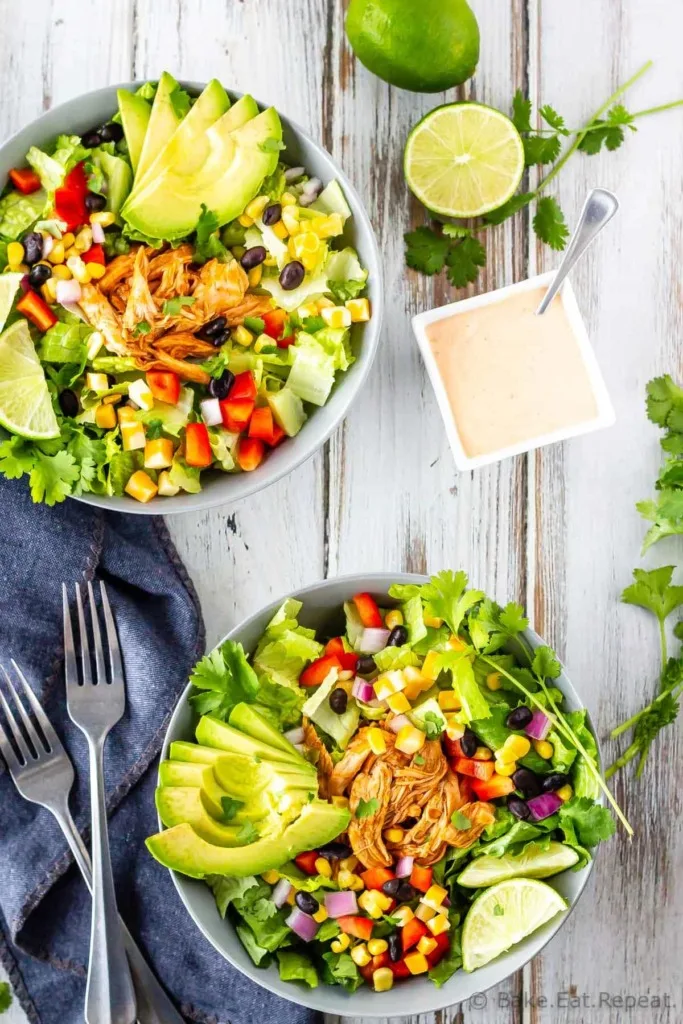 BBQ Chicken, corn, red peppers, black beans, and avocado in a romaine salad with creamy cilantro lime dressing