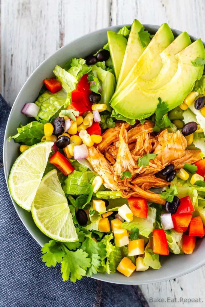 BBQ chicken chopped salad with corn, black beans, romaine lettuce, red pepper, red onion, and avocado and a creamy cilantro lime dressing.