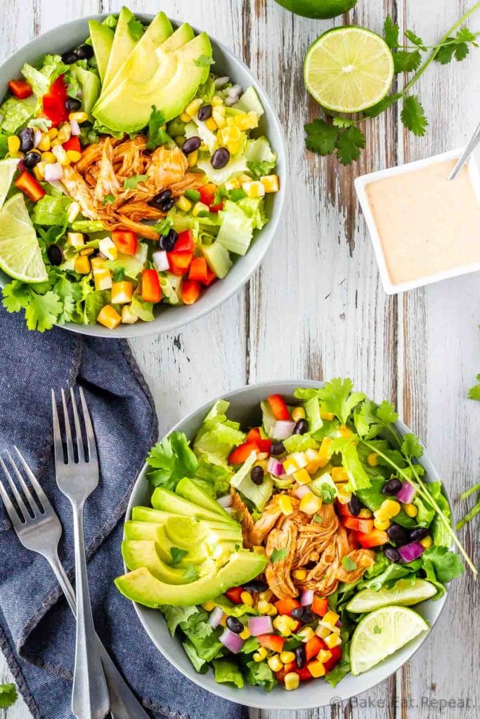 BBQ chicken chopped salad with corn, black beans, romaine lettuce, red pepper, red onion, and avocado and a creamy cilantro lime dressing.