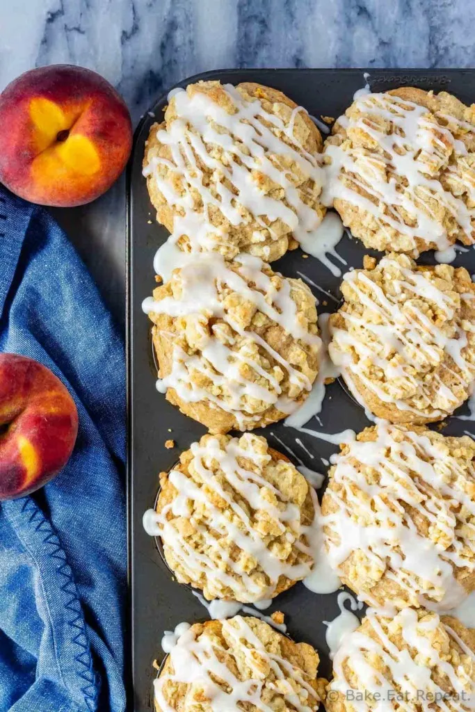 Muffins with fresh or frozen peaches and a crumb topping