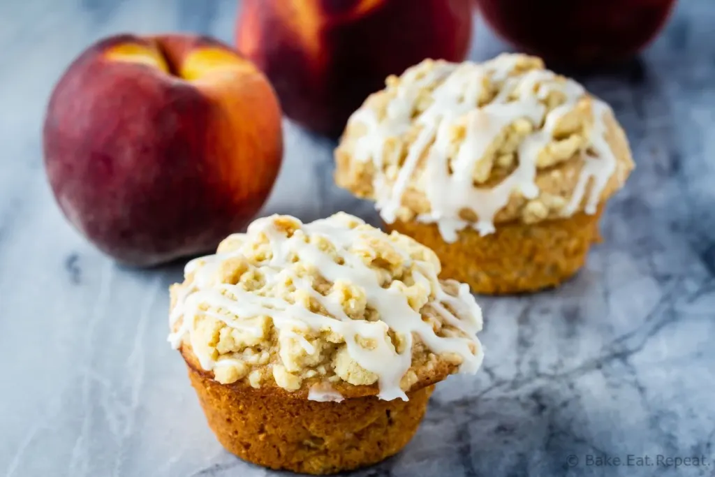 Peach crumb muffins with a vanilla glaze