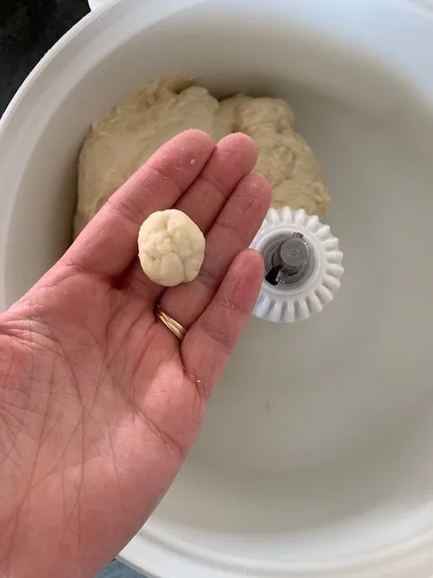 Bread dough rolled into a ball to show what it should look like if floured correctly.