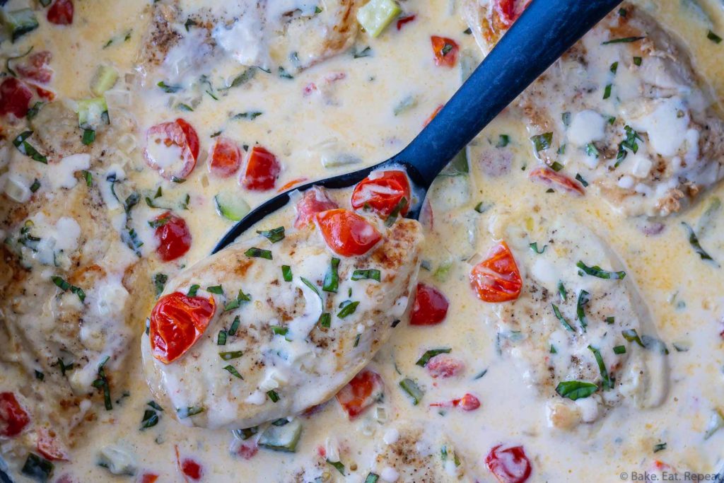 One pot chicken breast in a creamy garlic sauce with tomatoes, zucchini, and fresh basil