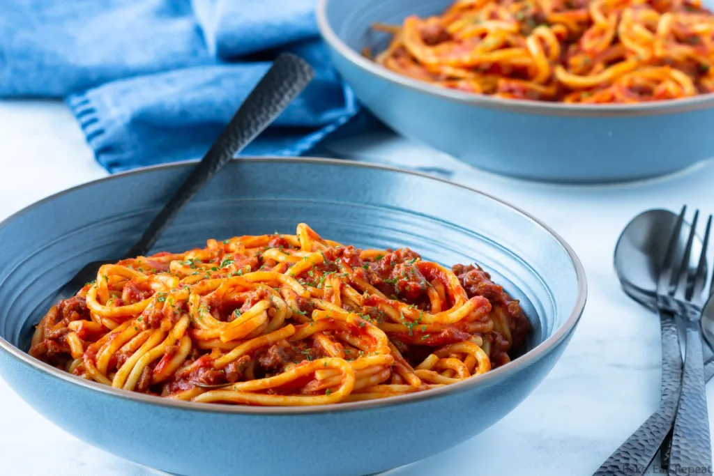 two bowls of spaghetti and meat sauce cooked in the Instant Pot.