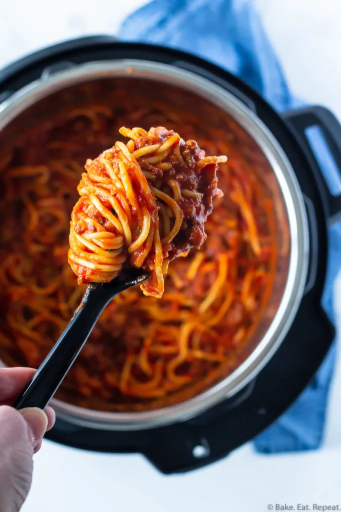 Spaghetti and meat sauce in the Instant Pot with a scoop of spaghetti.