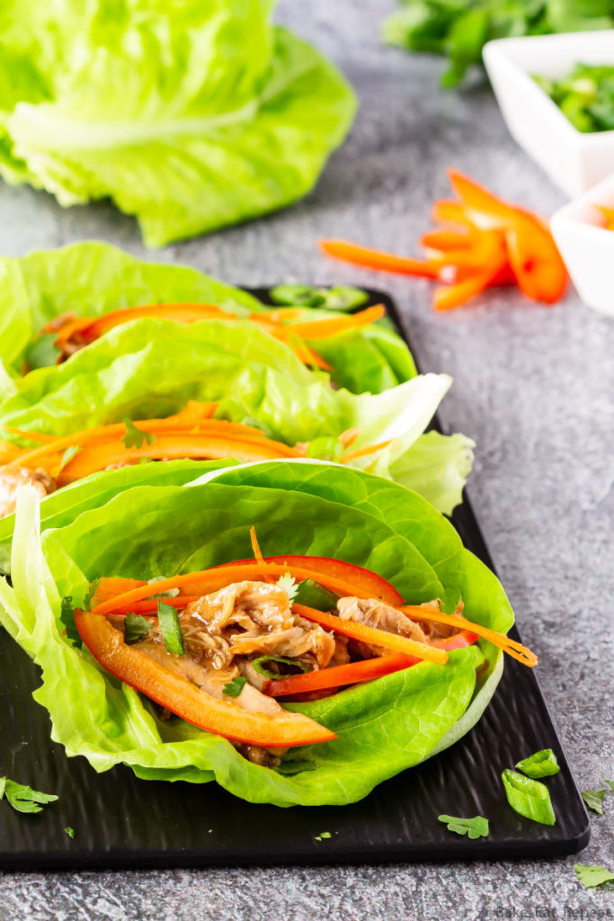 Easy to make slow cooker hoisin chicken lettuce wraps with toppings.