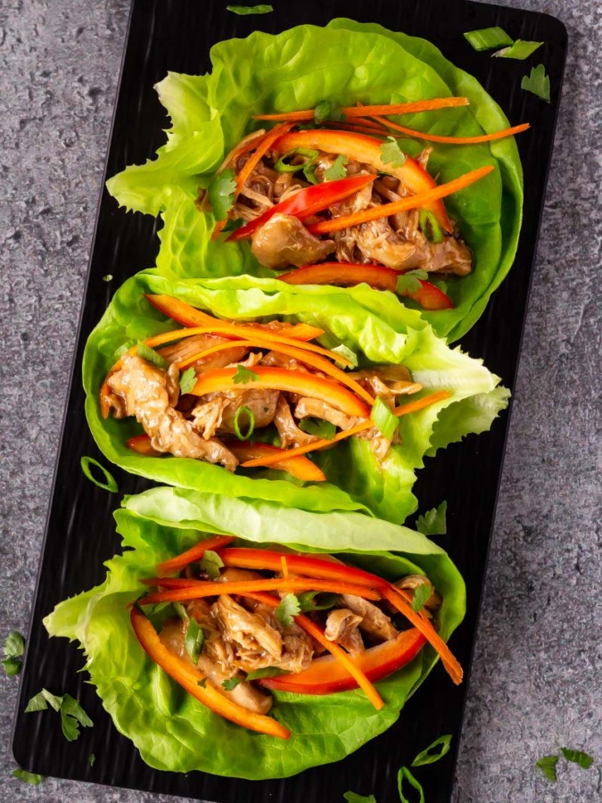 Slow cooker hoisin chicken lettuce wraps on a platter.