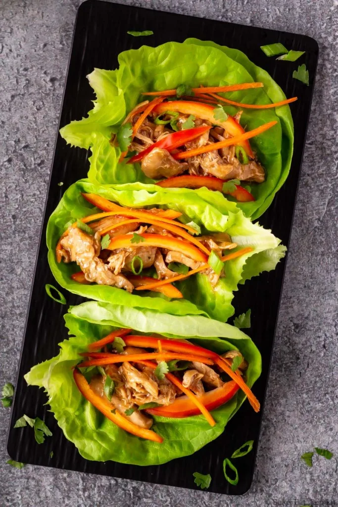 Slow cooker hoisin chicken lettuce wraps on a platter.