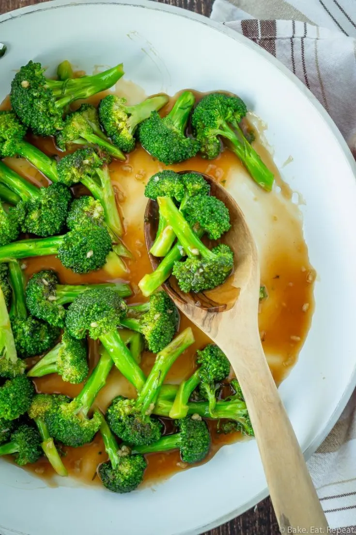 10 minute Asian broccoli stir fry in a skillet with a spoon.