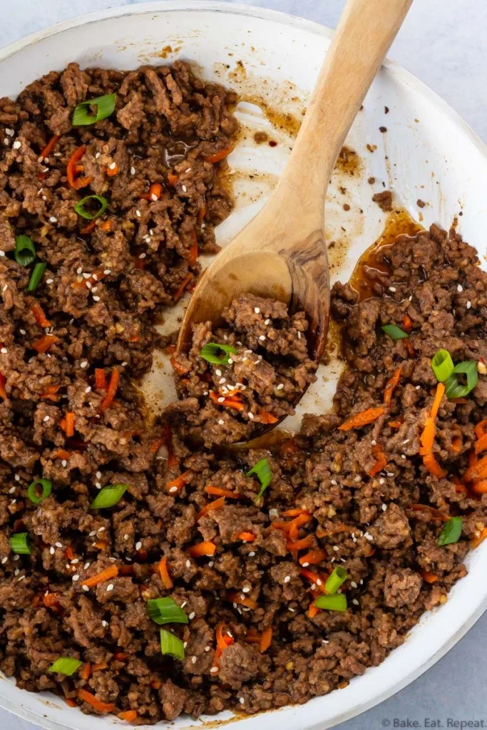 Korean beef in a skillet with a spoon.