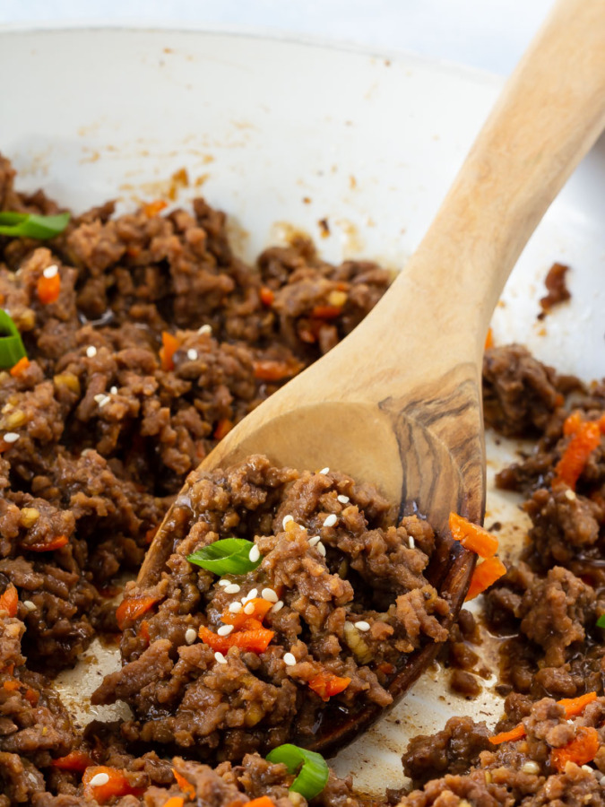 Korean ground beef with a spoon in a skillet.