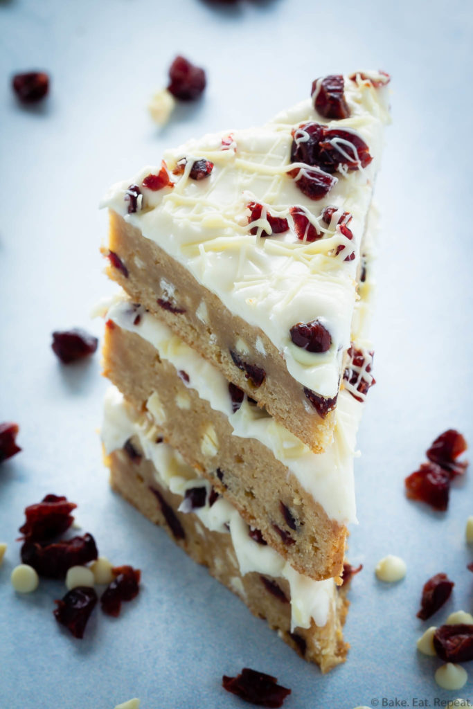 blondies with cranberries and white chocolate, topped with cream cheese frosting